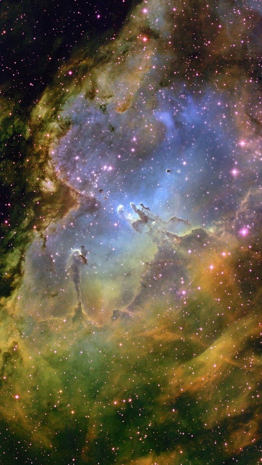 紫と青の星雲の中に無数の小さな星が散らばっています。