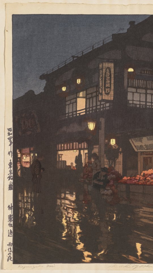 吉田博の木版画。雨上がりの夜の坂道に店の灯りが映り、傘の人が歩く。
